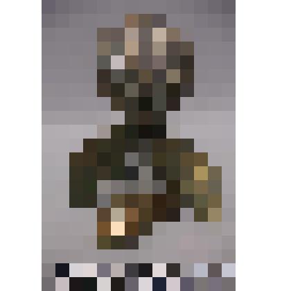 коллекция В.Ф. Лагодича. Фигурка «Древнего человека». На металлической основе из 7-ми слоев металла (3 латунь, 2 медь, 2мельхиор) установлен латунный стержень с припаянными руками-крыльями, к которому крепится голова, выточенная из камня. На металл нанесе