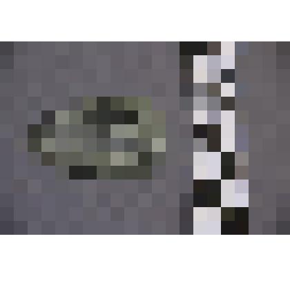 коллекция В.Ф. Лагодича. Талисман каменный лежачий, выполнен в виде головы человека. Камень серого цвета с чередованием от темного к светлому