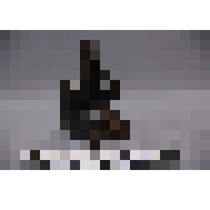 коллекция В.Ф. Лагодича. Талисман каменный стоящий на подставке, выполнен в виде головы человека. С гипертрофированными щеками, глазами прорезанными на сквозь и 3 полосами на лбу. Камень темно коричневого цвета