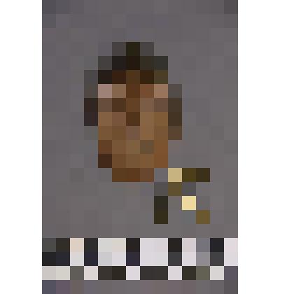 коллекция В.Ф. Лагодича. Талисман деревянный выполнен в виде головы человека. Вырезано схематичное лицо. На голове латунная бляшка смещенная в левую сторону. С левой стороны расположены 3 латунные пронизки прикрепленные к кольцу