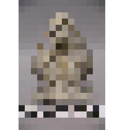 коллекция В.Ф. Лагодича. Талисман каменный стоящий на подставке. Выполнен в виде двухсторонней фантастической птицы. С одной стороны в правой лапе держит ящерицу, в левой ее хвост. С другой с другой яйца. Камень серого цвета